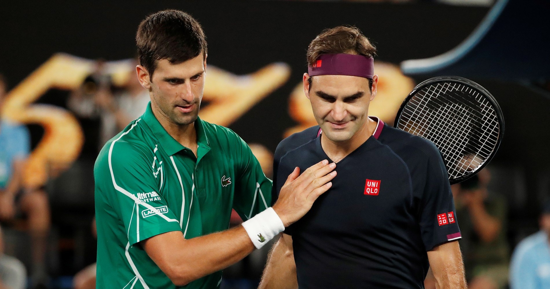 Federer and Djokovic at the net after their their Australian Open clash in 2020.