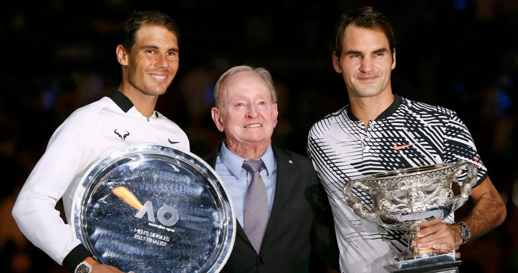 Roger Federer and Rafael Nadal pose with Rod Laver and their trophies in Australia in 2017