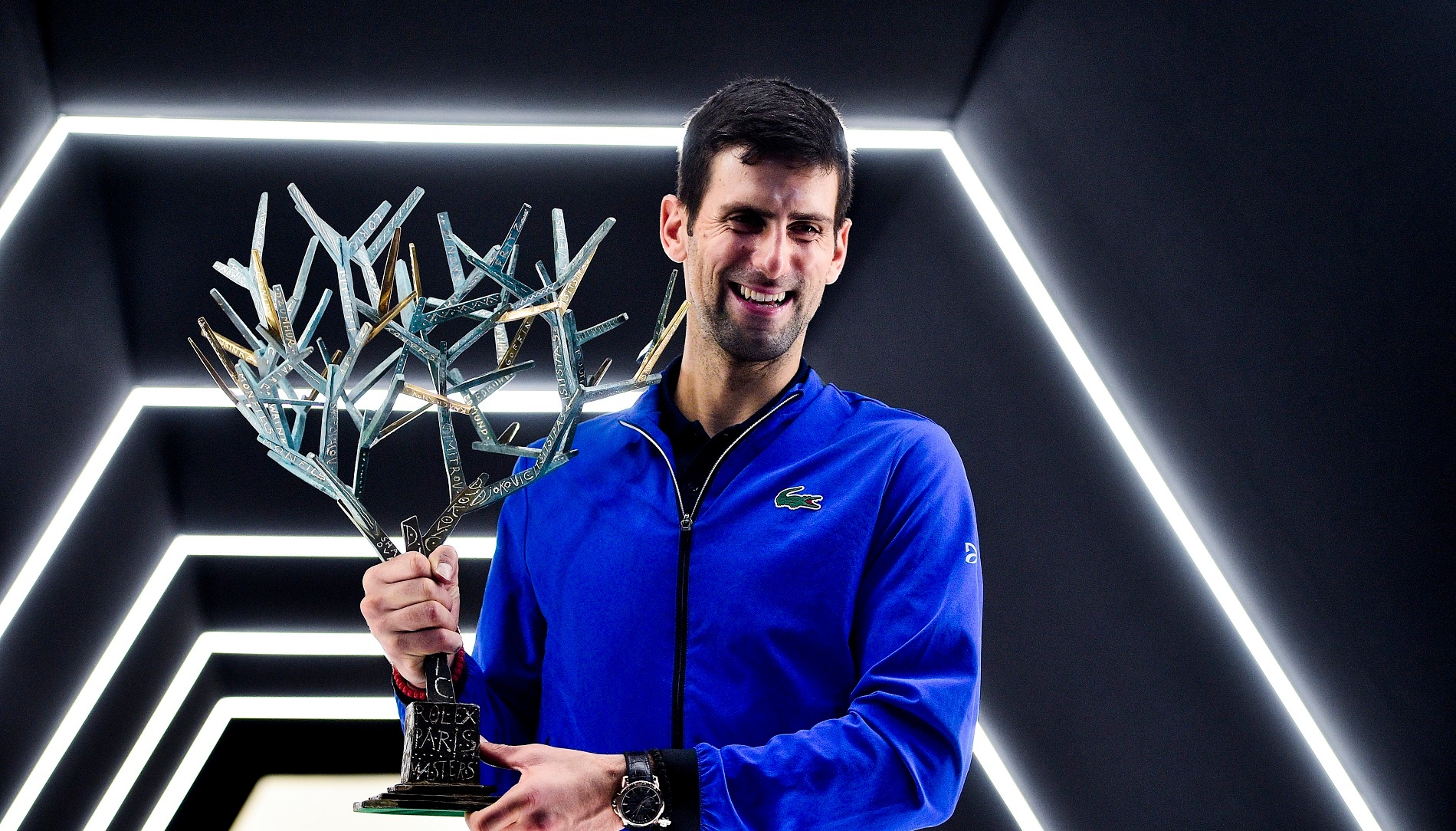 Novak Djokovic poses with the 2019 winner's trophy