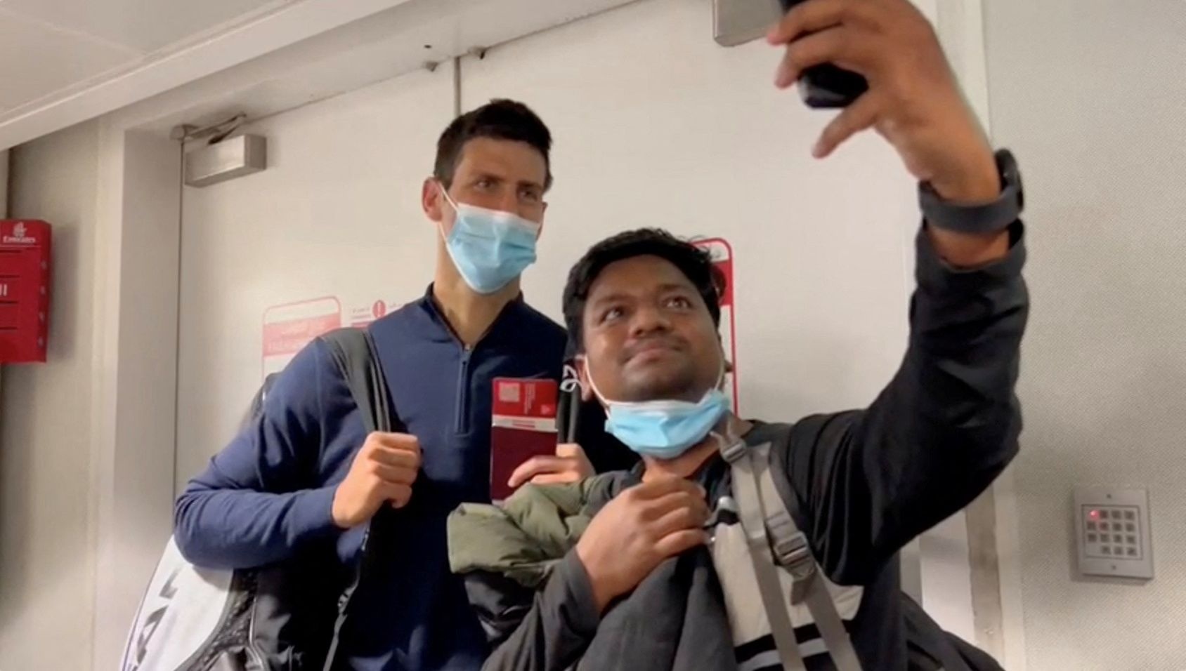 Novak Djokovic poses for a selfie after landing at Dubai Airport after the Australian Federal Court upheld a government decision to cancel his visa to play in the Australian Open, in Dubai, United Arab Emirates, January 17, 2022.