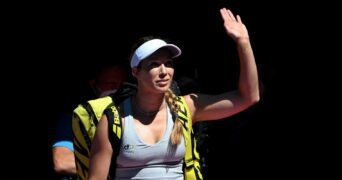 Danielle Collins of the U.S. waves at fans at the 2022 Australian Open