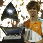 Russia's Andrey Rublev celebrates with the trophy after winning the Dubai Tennis Championships final match against Czech Republic's Jiri Vesely