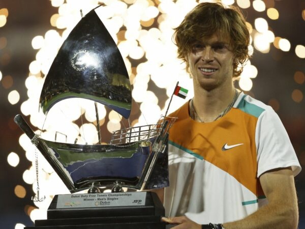 Russia's Andrey Rublev celebrates with the trophy after winning the Dubai Tennis Championships final match against Czech Republic's Jiri Vesely