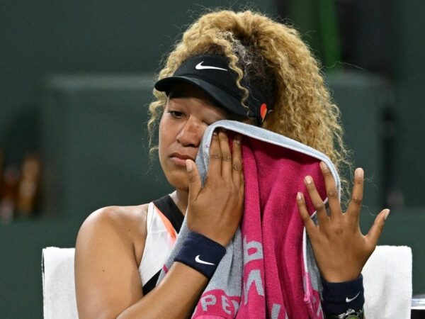 Naomi Osaka wipes her face as she talks to referee Claire Wood after a spectator disrupted play, yelling "Naomi you suck," before the start of her 2nd round match against Veronika Kudermetova at the BNP Paribas open at the Indian Wells Tennis Garden.