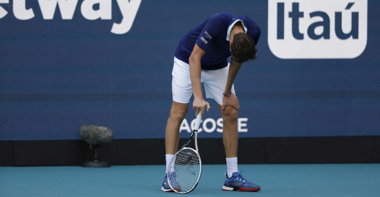 Daniil Medvedev bends over from fatigue after losing a point during his men's singles quarterfinal in the Miami Open at Hard Rock Stadium.