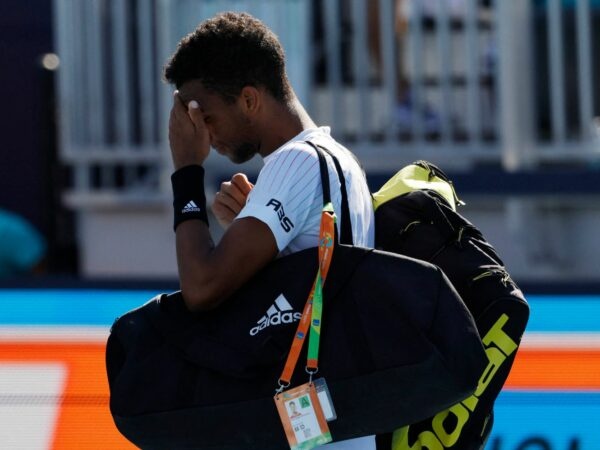Felix Auger-Aliassime walks off the court after his second round men's singles match in the Miami Open at Hard Rock Stadium.