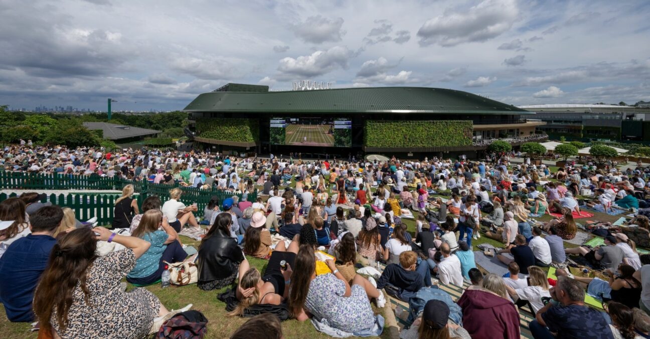 Spectators watch the men's final on a large screen as they sit on Henman Hill at the All England Lawn Tennis and Croquet Club, London, Britain