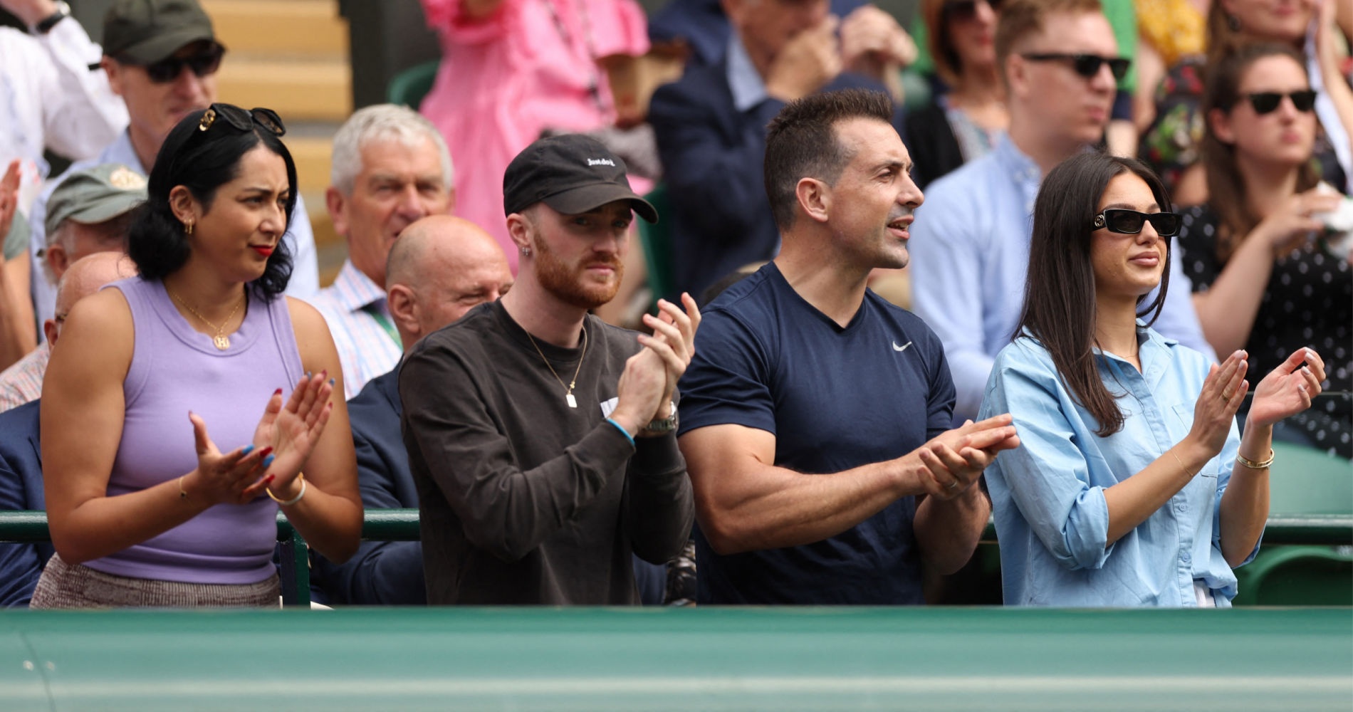 The support team of Nick Kyrgios cheers him during his quarter-final match at 2022 Wimbledon