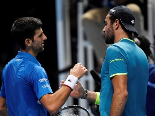 Tennis - ATP Finals - The O2, London, Britain - November 10, 2019 Serbia's Novak Djokovic shakes hands with Italy's Matteo Berrettini after winning their group stage match