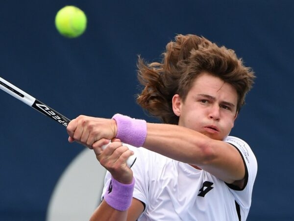 J.J. Wolf of the United States plays a shot against Frances Tiafoe of the United States in first round qualifying play for the National Bank Open at the Aviva Centre.