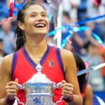 Emma Raducanu of Great Britain celebrates with the championship trophy after her match on day thirteen of the 2021 U.S. Open tennis tournament at USTA Billie Jean King National Tennis Center.