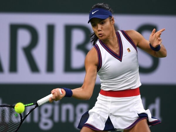 Emma Raducanu (GBR) hits a shot against Aliaksandra Sasnovich (BLR) at Indian Wells Tennis Garden.