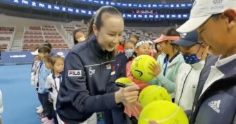 Chinese tennis player Peng Shuai signs large-sized tennis balls at the opening ceremony of Fila Kids Junior Tennis Challenger Final in Beijing, China November 21, 2021