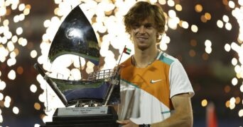 Russia's Andrey Rublev celebrates with the trophy after winning the Dubai Tennis Championships final match against Czech Republic's Jiri Vesely