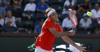 Taylor Fritz returns a shot against Jaume Munar of Spain during the 2022 BNP Paribas Open at Indian Wells Tennis Garden in Indian Wells, California.