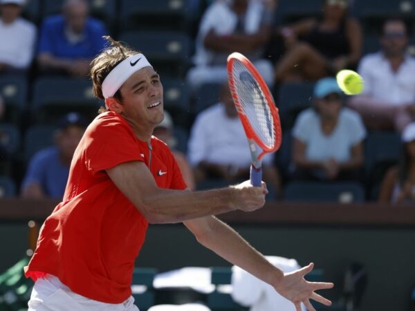 Taylor Fritz returns a shot against Jaume Munar of Spain during the 2022 BNP Paribas Open at Indian Wells Tennis Garden in Indian Wells, California.