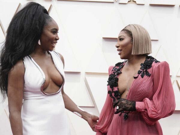 Venus Williams, left, and Serena Williams arrive at the Oscars on Sunday, March 27, 2022, at the Dolby Theatre in Los Angeles.