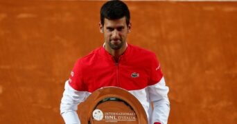 Serbia's Novak Djokovic poses with the runners up trophy after losing against Spain's Rafael Nadal in the final of the Italian Open in Rome