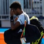 Felix Auger-Aliassime walks off the court after his second round men's singles match in the Miami Open at Hard Rock Stadium.