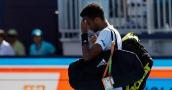 Felix Auger-Aliassime walks off the court after his second round men's singles match in the Miami Open at Hard Rock Stadium.