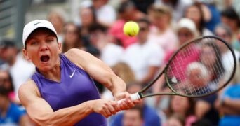 Romania's Simona Halep celebrates winning the first set during her first round match against France's Alize Cornet at the Italian Open