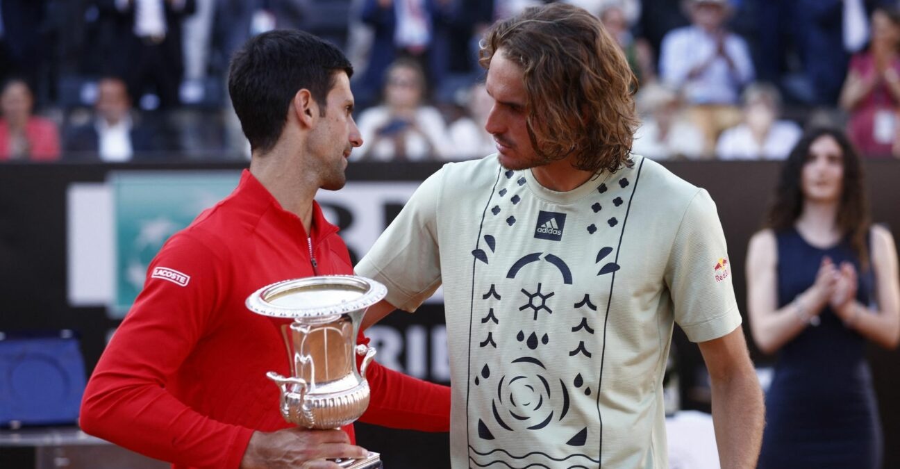 Serbia's Novak Djokovic celebrates with the trophy after winning the final alongside Greece's Stefanos Tsitsipas