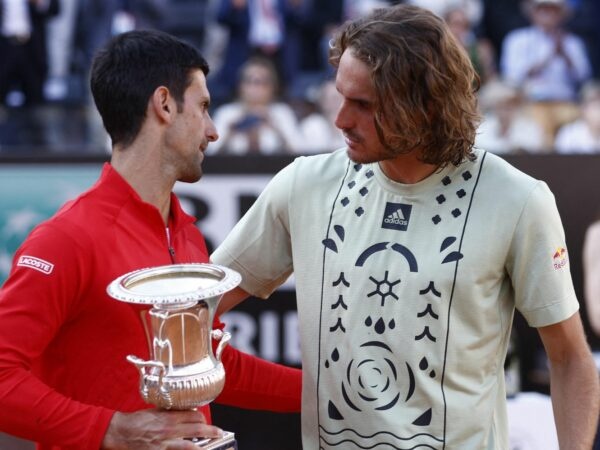 Serbia's Novak Djokovic celebrates with the trophy after winning the final alongside Greece's Stefanos Tsitsipas