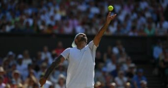 Nick Kyrgios serves during the 2022 Wimbledon final