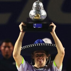 Australia's Alex de Minaur celebrates with the trophy after winning the Mexican Open