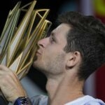 Hubert Hurkacz of Poland kisses his winning trophy after defeating Andrey Rublev in Shanghai