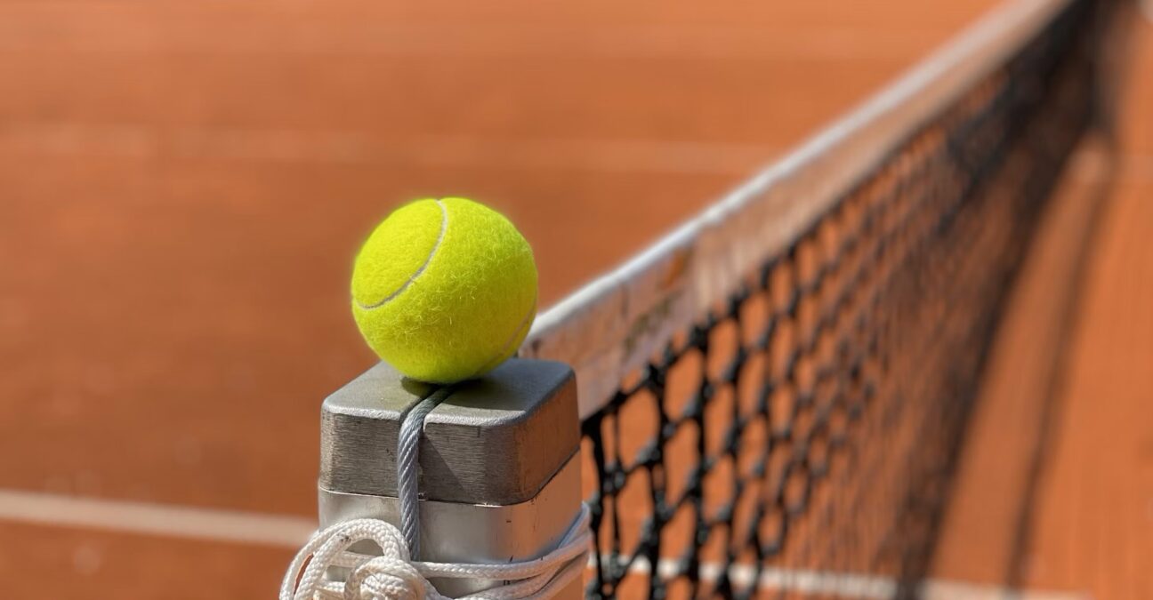 Tennis ball on net post