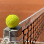 Tennis ball on net post