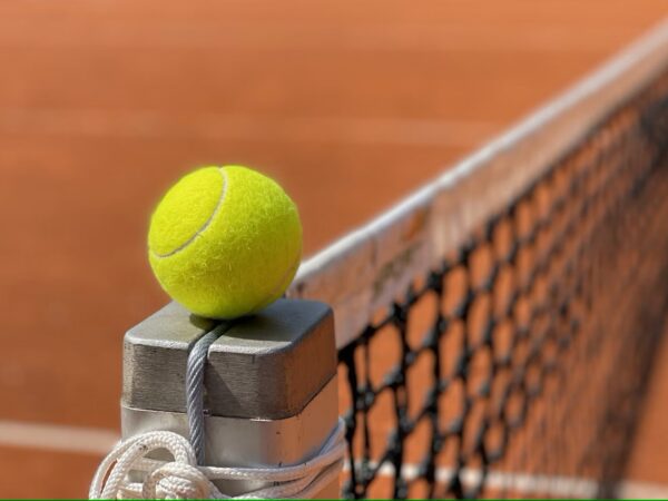 Tennis ball on net post