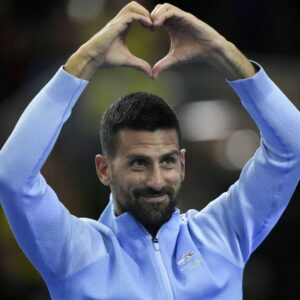 Novak Djokovic gestures to the crowd during an exhibition tennis match against Argentina's Juan Martin Del Potro in Buenos Aires.