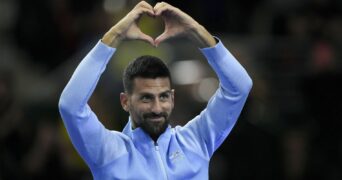 Novak Djokovic gestures to the crowd during an exhibition tennis match against Argentina's Juan Martin Del Potro in Buenos Aires.