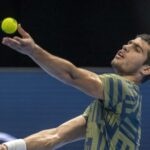 Carlos Alcaraz toss the ball for a serve during his first round match against Jack Draper in Basel in 2022