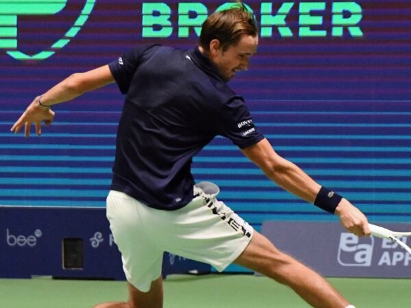 Daniil Medvedev hits a slice backhand against Novak Djokovic during their semi-final in Astana in 2022