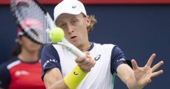 Emil Ruusuvuori hits a forehand return against Stan Wawrinka at Montreal in 2022.