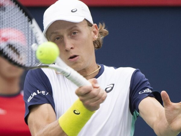 Emil Ruusuvuori hits a forehand return against Stan Wawrinka at Montreal in 2022.