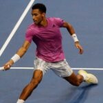 Felix Auger Aliassime hits a forehand close to the net in Basel in 2022