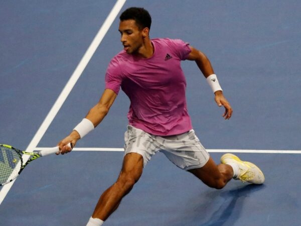 Felix Auger Aliassime hits a forehand close to the net in Basel in 2022