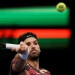 Grigor Dimitrov hits a forehand against Marcos Giron in Vienna in 2022