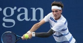 Marc-Andrea Huesler is hitting a backhand against Denis Shapovalov at the US Open 2022