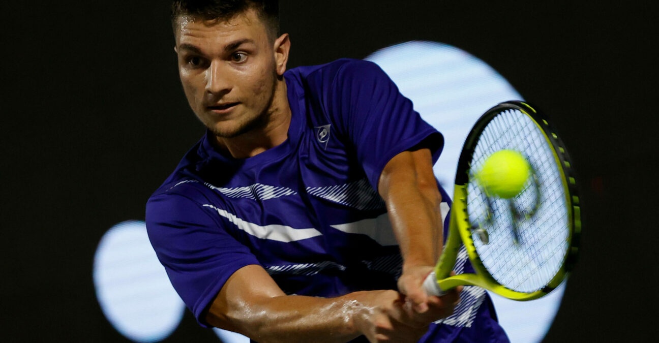 Miomir Kecmanovic is hitting a backhand during a match in Napoli in 2022